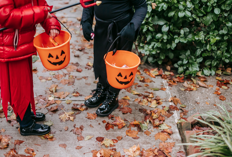kids with trick or treat pumpkin buckets